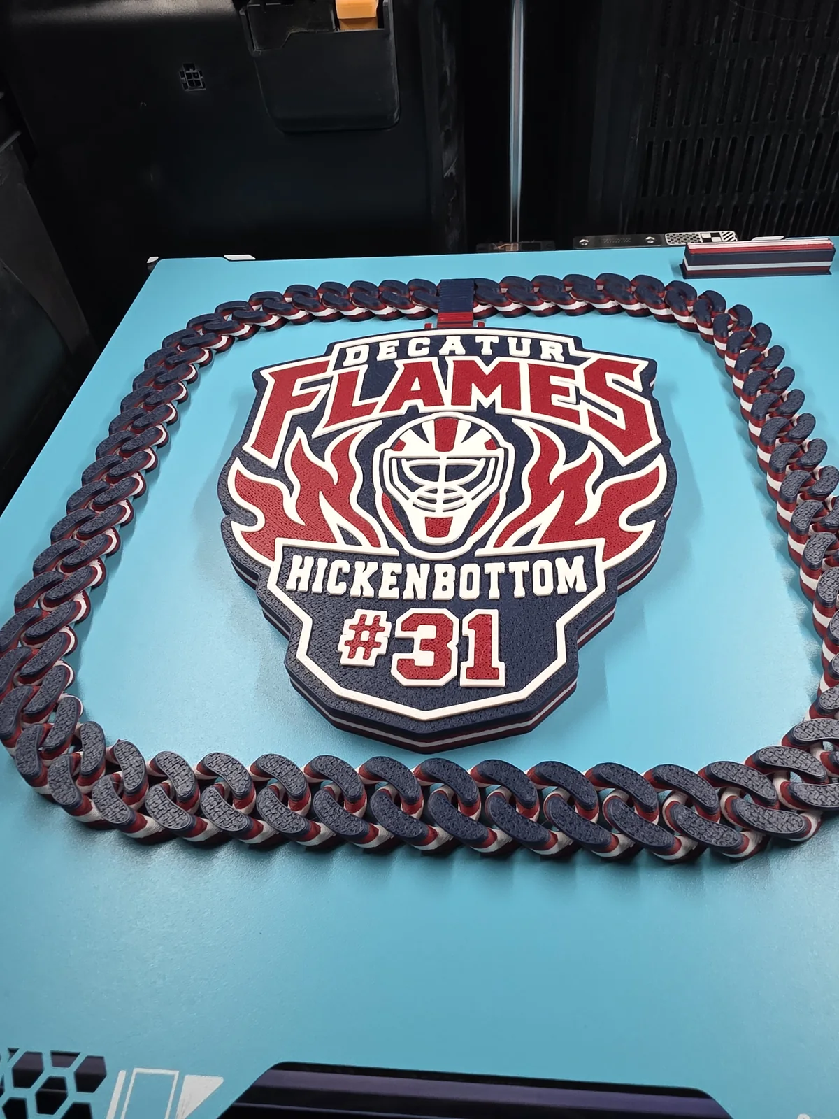 Red, white, and black Decatur Flames number 31 plaque