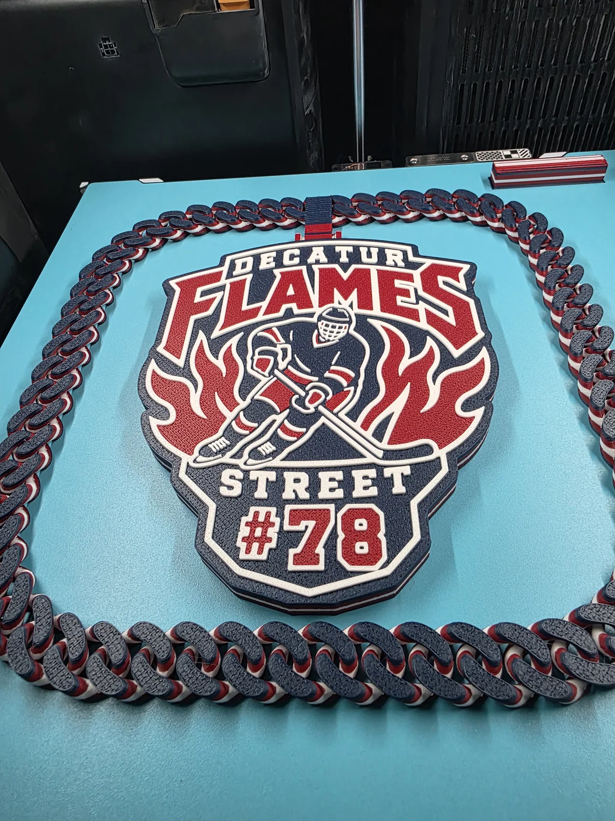 Red, white, and black Decatur Flames number 78 plaque