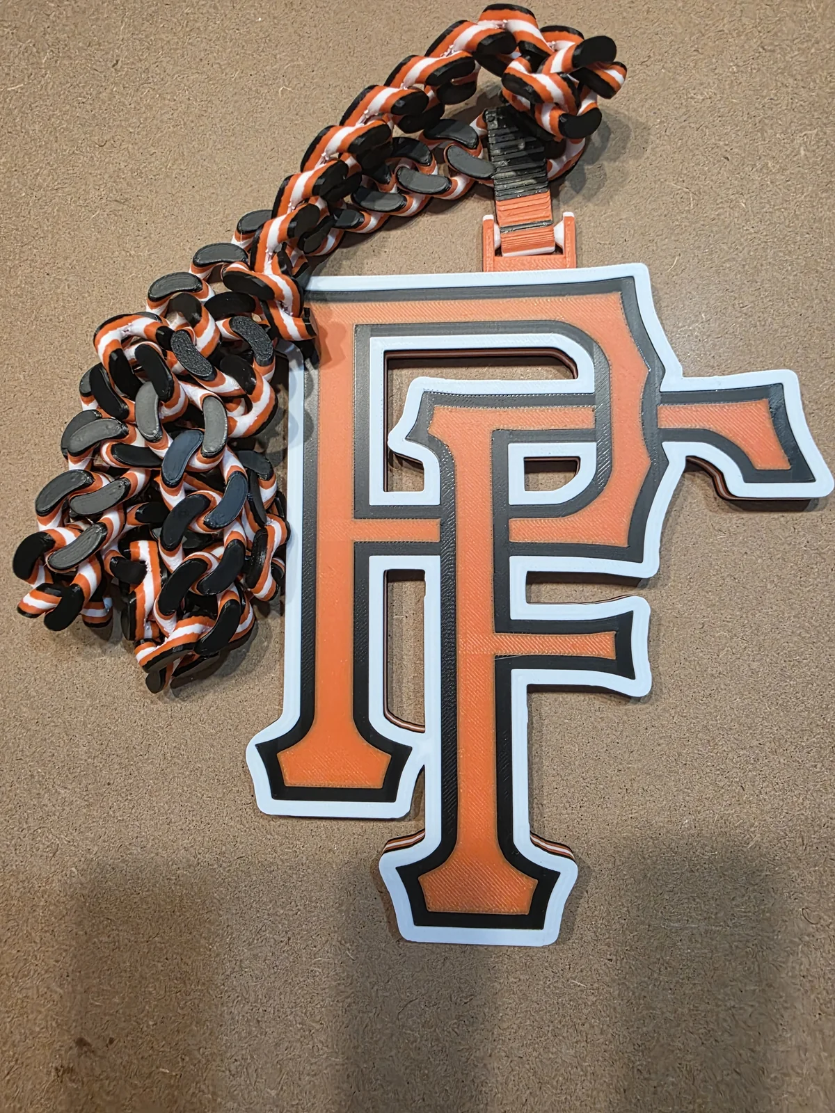 Orange, white, and black PF pendant with a printed chain