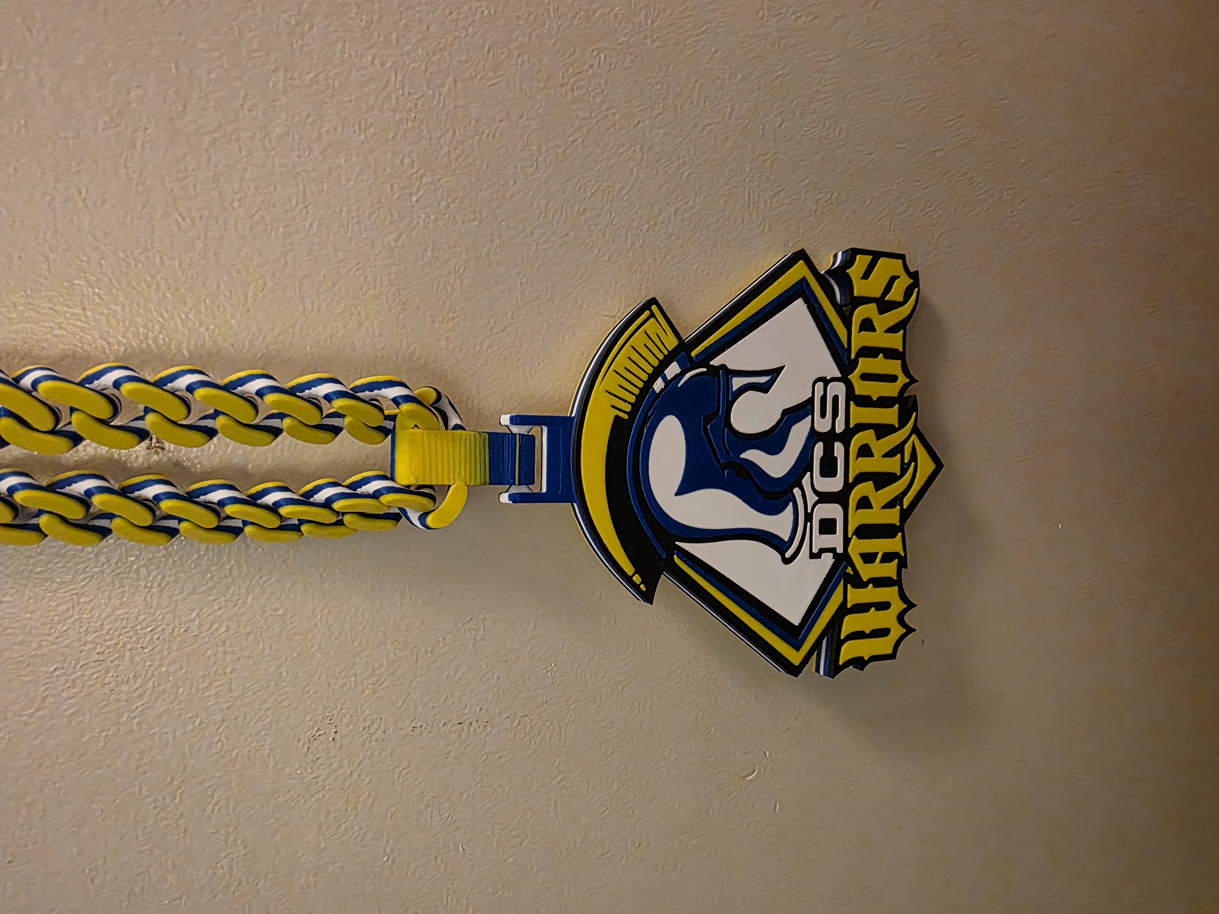 Warriors character pendant with a yellow, dark blue, and white chain